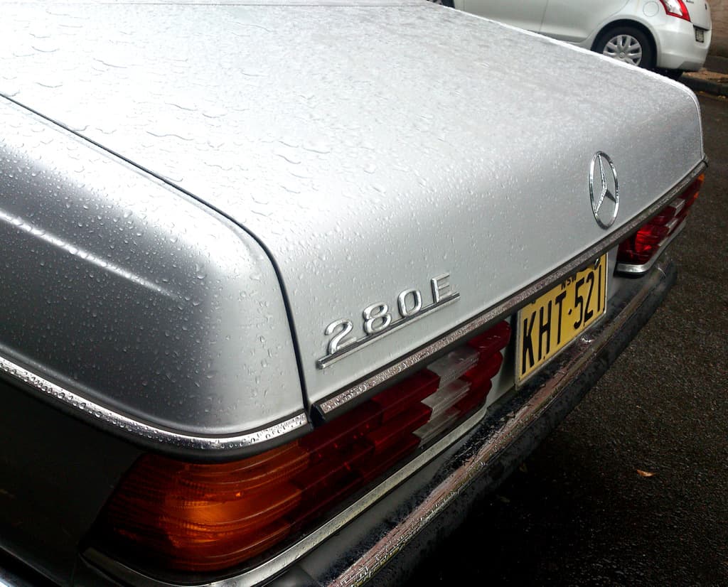 Ein Fahrzeug mit Mercedes-Benz-Logo fährt auf der Straße neben einem anderen Fahrzeug.