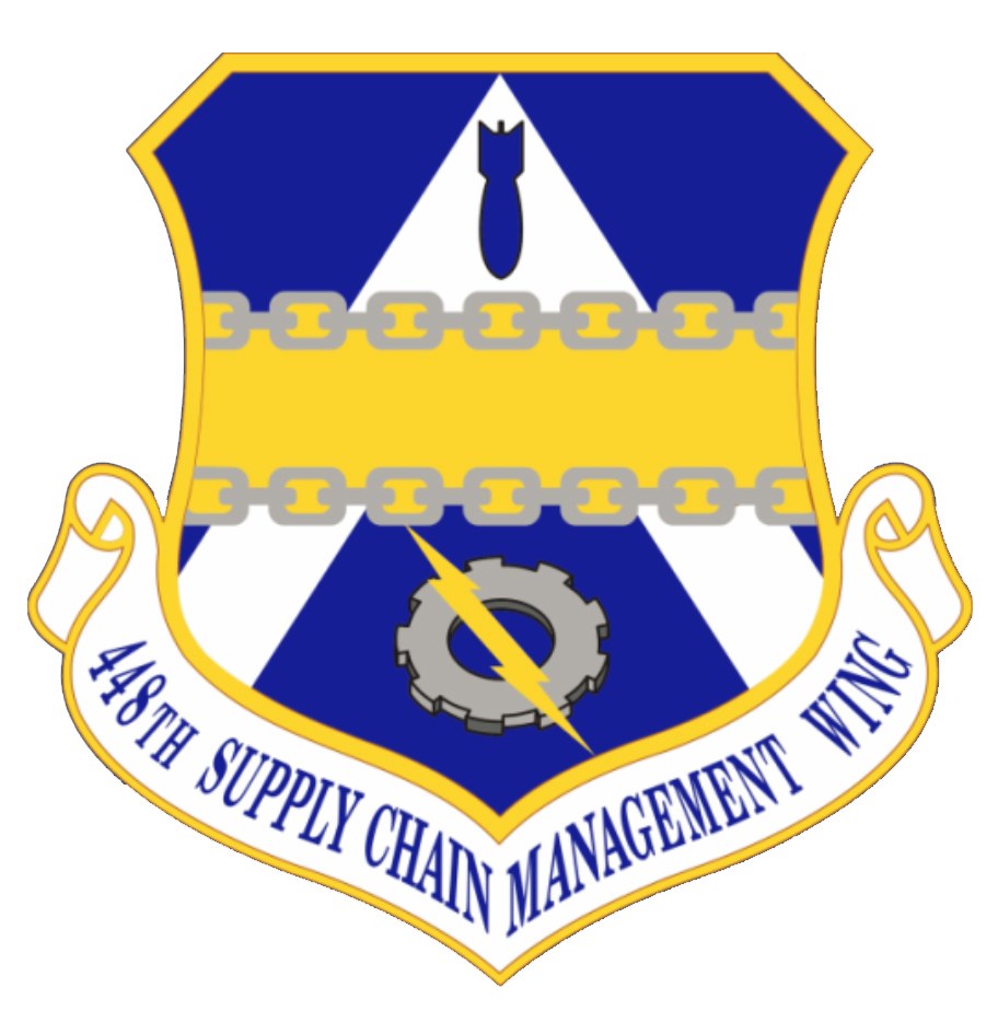 Logo des 48. Versorgungsgeschwader mit einem blauen Schild mit einem weißen Stern und einem weißen Banner mit der Aufschrift "Versorgungsgeschwader" in blau, alles von einem weißen Rand und schwarzem Text umgeben.