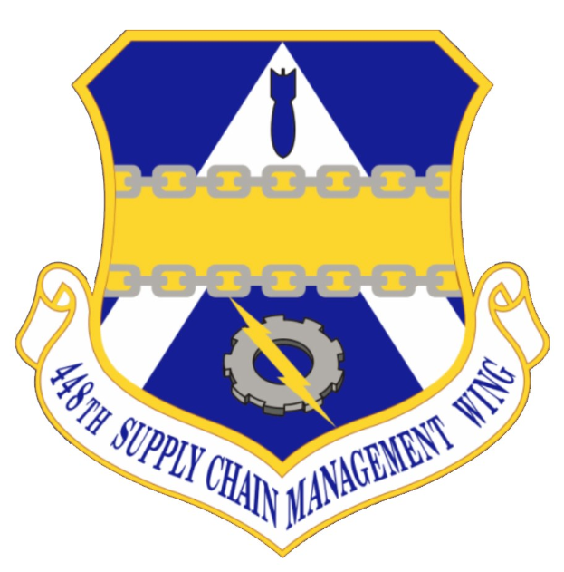 Logo des 48. Versorgungsgeschwader mit einem blauen Schild mit einem weißen Stern und einem weißen Banner mit der Aufschrift "Versorgungsgeschwader" in blau, alles von einem weißen Rand und schwarzem Text umgeben.