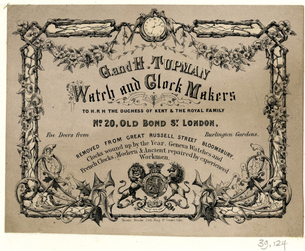 Schwarze und weiße Werbung für Grand H. Tupman Uhren und Uhrmacher mit einem Zifferblatt-Design mit dekorativem Rahmen und Text.