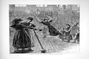 Eine Schwarz-Weiß-Radierung von Kindern, die mit einem Ball in einem Turnsaal spielen, mit zwei Mädchen in der Mitte, die Stöcke halten, und anderen Kindern drumherum, und Text unten, der "A Ladies' Class at the German Gymnasium" lautet.