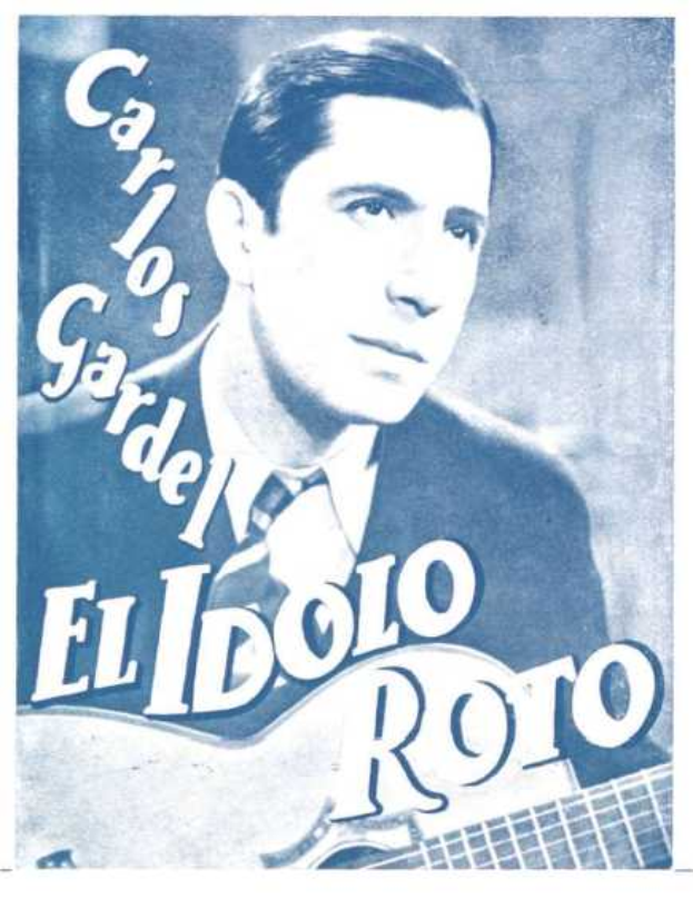 Ein Plakat, das El Idolo Roro, einen spanischen S├Ąnger-Songwriter, zeigt, der eine Gitarre h├Ąlt, ein wei├čes Hemd und einen schwarzen Anzug tr├Ągt, mit zur├╝ckgek├Ąmmtem Haar und einem ernsten Gesichtsausdruck, vor einem hellblauen Hintergrund mit fetter schwarzer Schrift.